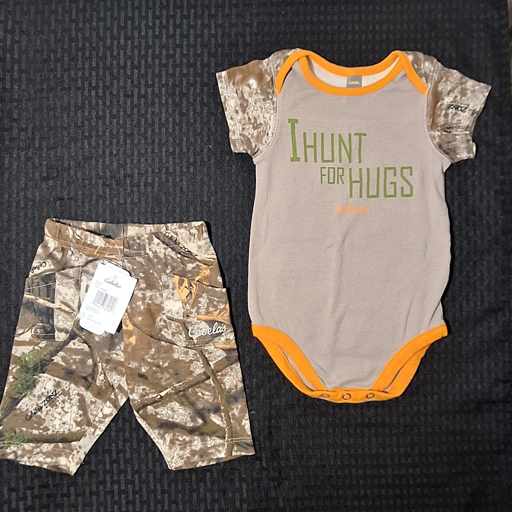 Cabelas 3-6 month old Two Piece. "I Hunt For Hugs" shirt. Camo pants. NWT